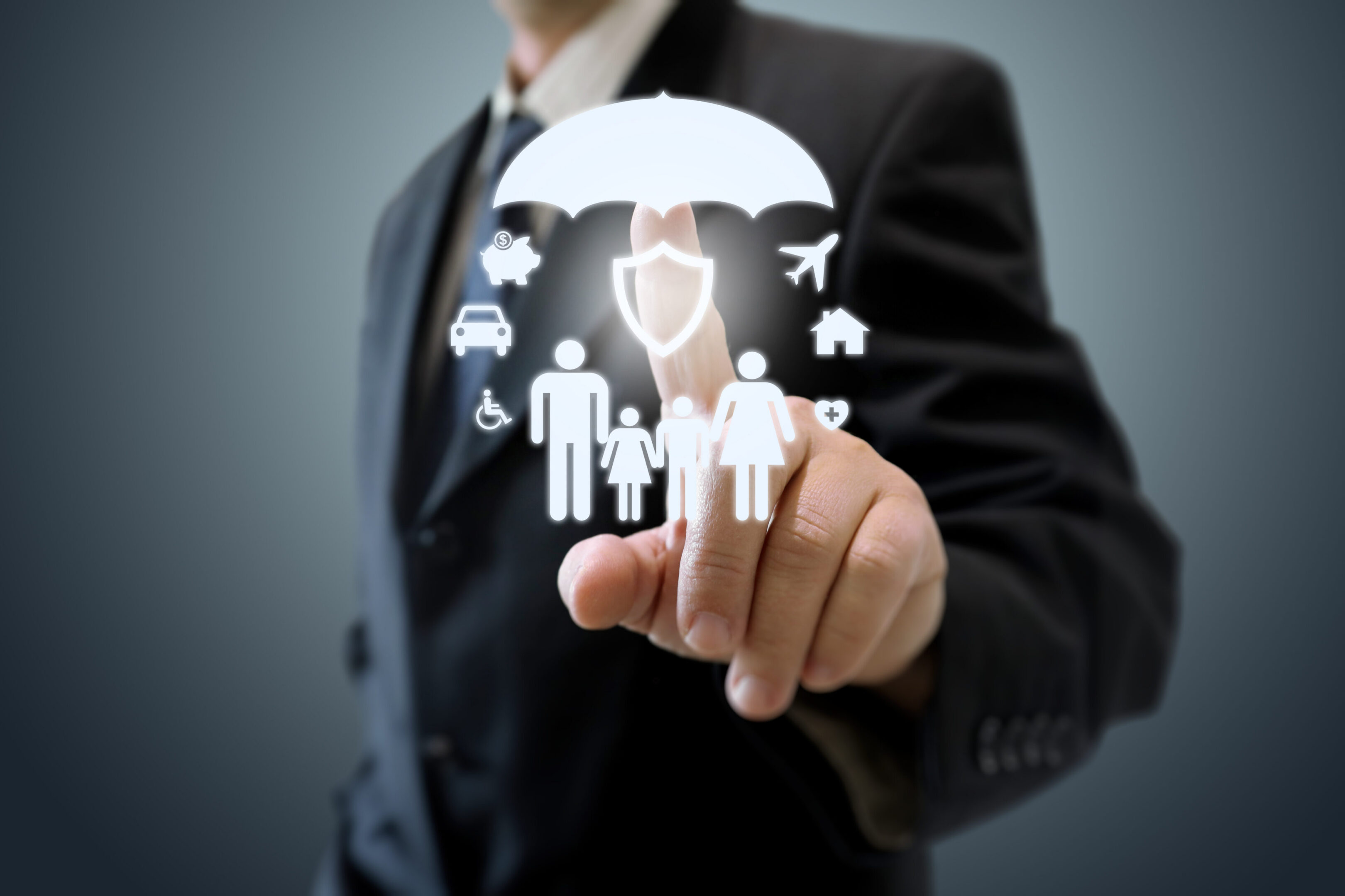 Businessman interacting with digital insurance icons.
